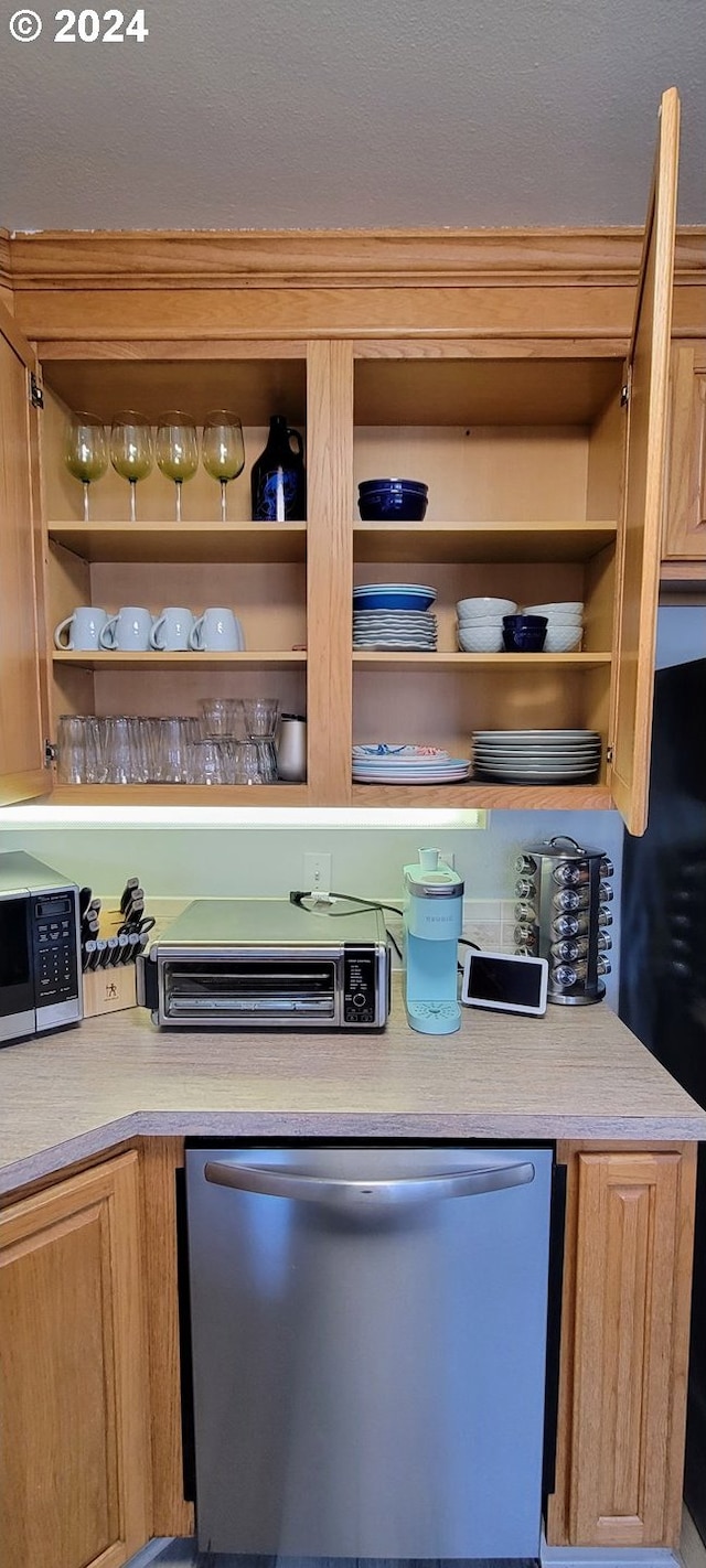 kitchen featuring light countertops, open shelves, and black appliances