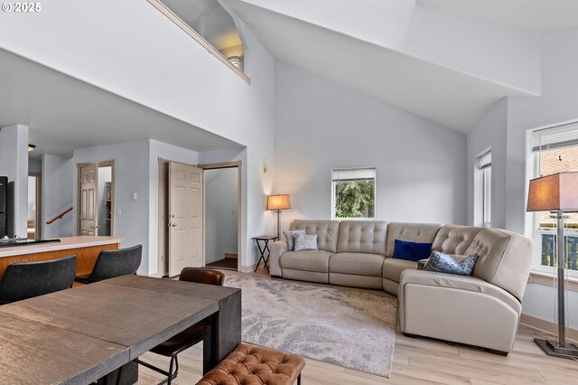 3979 NE Johns Ave, Neotsu, OR 97364 - living room with high vaulted ceiling, light wood-type flooring, and baseboards