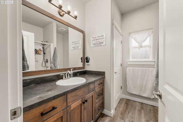 360 NE Rose Ridge Dr, Winston, OR 97496 - full bath with vanity, wood finished floors, and a shower