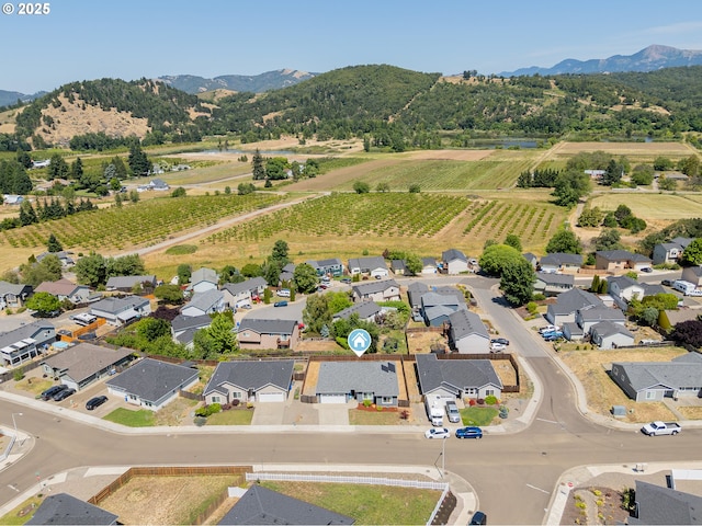 360 NE Rose Ridge Dr, Winston, OR 97496 - overview of rural landscape featuring a mountain backdrop, rows of crops, and nearby suburban area