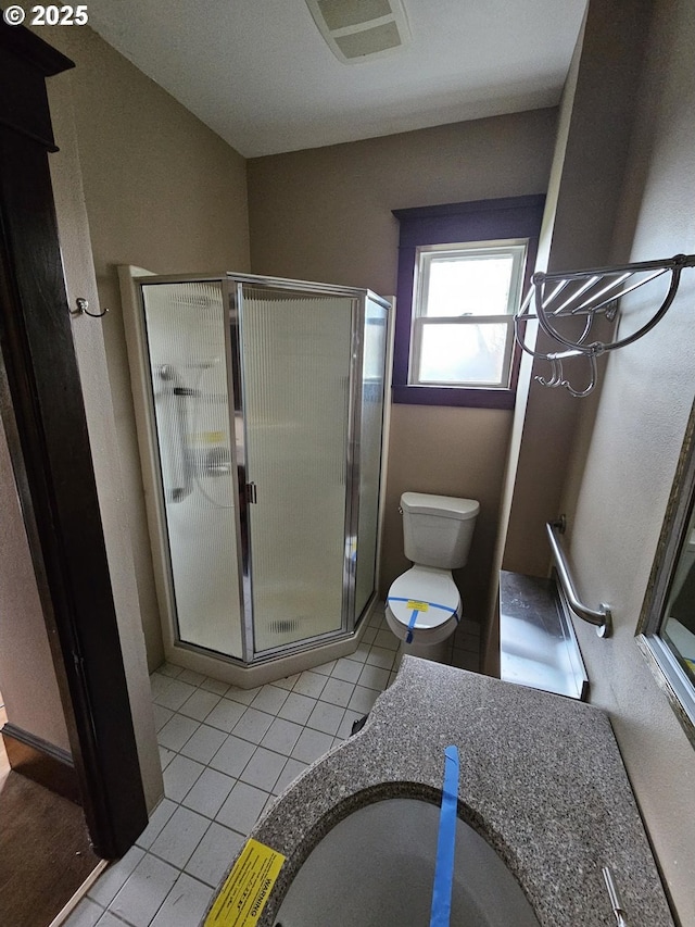 full bathroom with tile patterned floors, vanity, toilet, and a shower stall