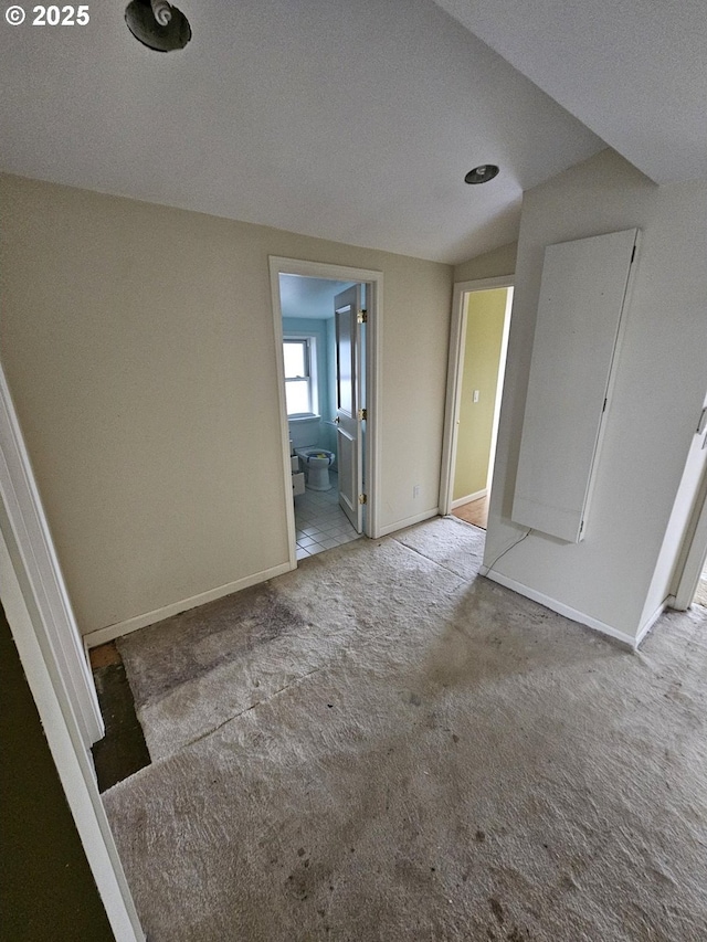 carpeted spare room with baseboards