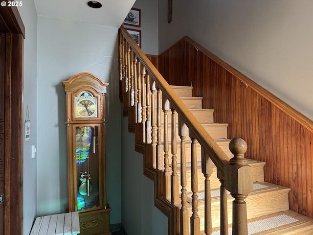 stairs featuring wooden walls