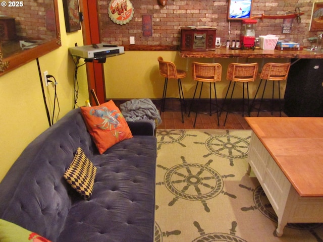 living room with bar area and brick wall