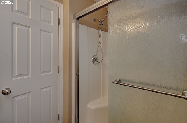 bathroom with a shower with door