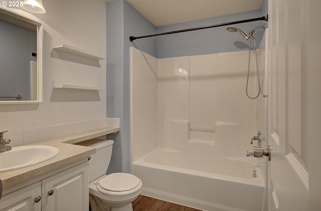 full bathroom with vanity, hardwood / wood-style floors, shower / bathtub combination, and toilet