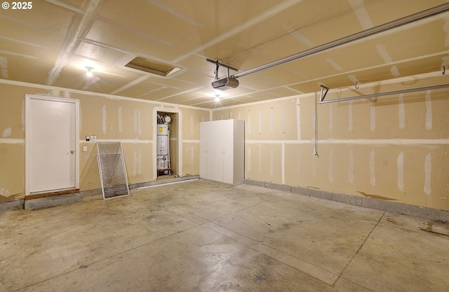 garage featuring a garage door opener and water heater