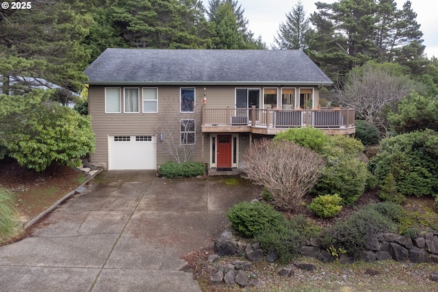 view of front of home with a deck and a garage