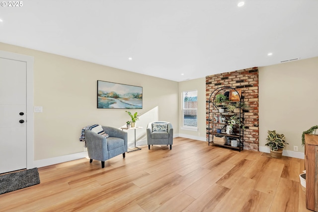 sitting room featuring light hardwood / wood-style flooring