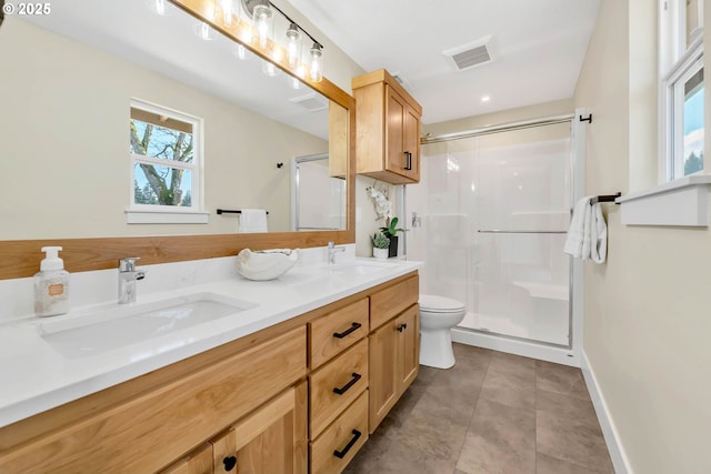 bathroom featuring vanity, tile patterned flooring, a shower with shower door, and toilet