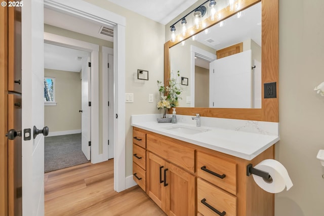 bathroom with vanity and hardwood / wood-style floors