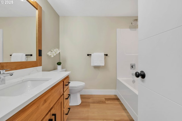 full bathroom with vanity, hardwood / wood-style flooring, shower / tub combination, and toilet