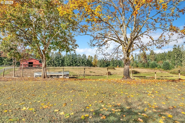 view of yard with a rural view and an outbuilding