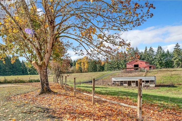 view of yard with a rural view and an outbuilding