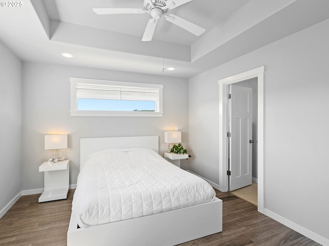 1793 SE Jonathan Ave, Dallas, OR 97338 - bedroom with baseboards, wood finished floors, recessed lighting, a tray ceiling, and ceiling fan