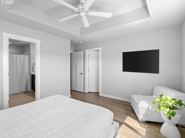 1793 SE Jonathan Ave, Dallas, OR 97338 - bedroom featuring a tray ceiling, wood finished floors, and baseboards