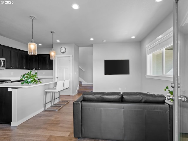 1793 SE Jonathan Ave, Dallas, OR 97338 - living area featuring recessed lighting, light wood-type flooring, stairs, and baseboards