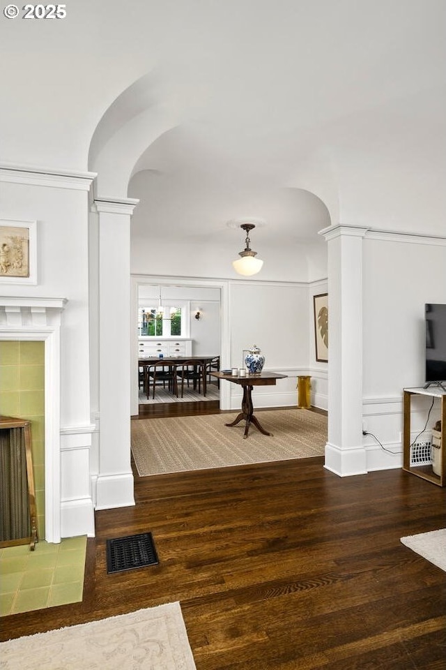 2424 NW Northrup St, Portland, OR 97210 - living area featuring decorative columns, arched walkways, wood finished floors, and a decorative wall