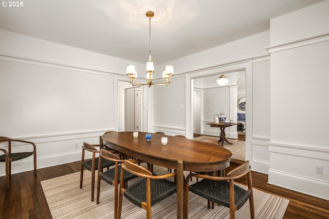 2424 NW Northrup St, Portland, OR 97210 - dining room with a chandelier, a decorative wall, wood finished floors, and wainscoting