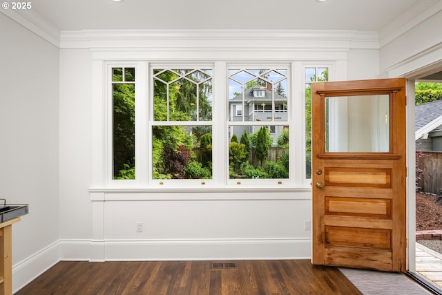 2424 NW Northrup St, Portland, OR 97210 - entryway featuring healthy amount of natural light, ornamental molding, dark wood-type flooring, and baseboards