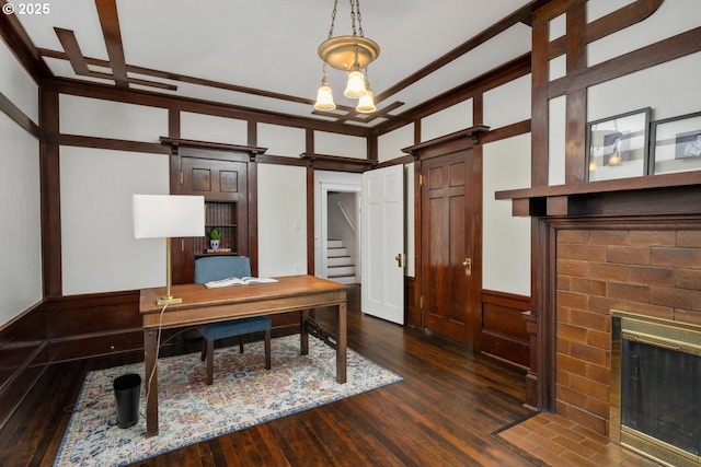 2424 NW Northrup St, Portland, OR 97210 - office space with dark wood finished floors, a barn door, a fireplace, and wainscoting