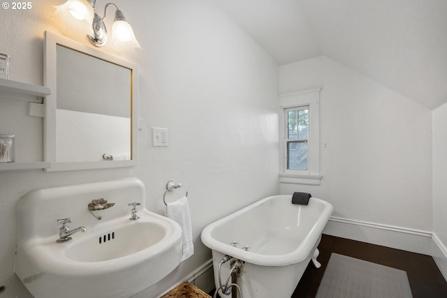 2424 NW Northrup St, Portland, OR 97210 - bathroom with lofted ceiling, a freestanding tub, and baseboards