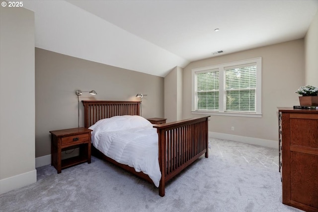 bedroom featuring visible vents, light colored carpet, baseboards, and lofted ceiling