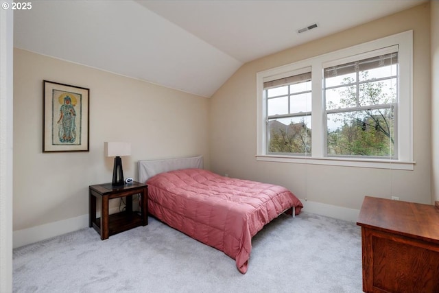 carpeted bedroom with visible vents, baseboards, and vaulted ceiling