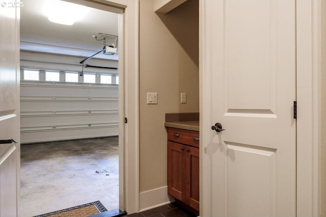 interior space with concrete floors and baseboards