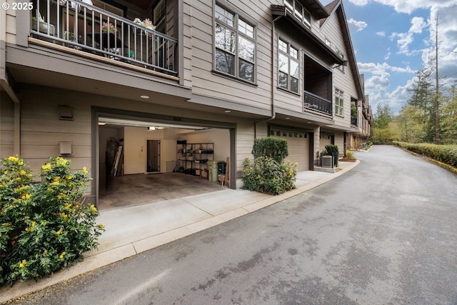 view of property exterior with a garage and concrete driveway