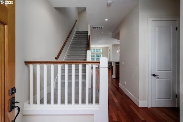 interior space with visible vents, recessed lighting, wood finished floors, stairs, and baseboards