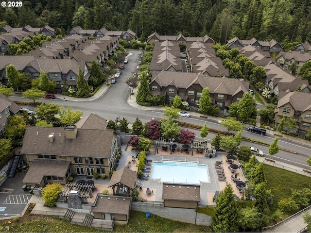 birds eye view of property with a wooded view and a residential view