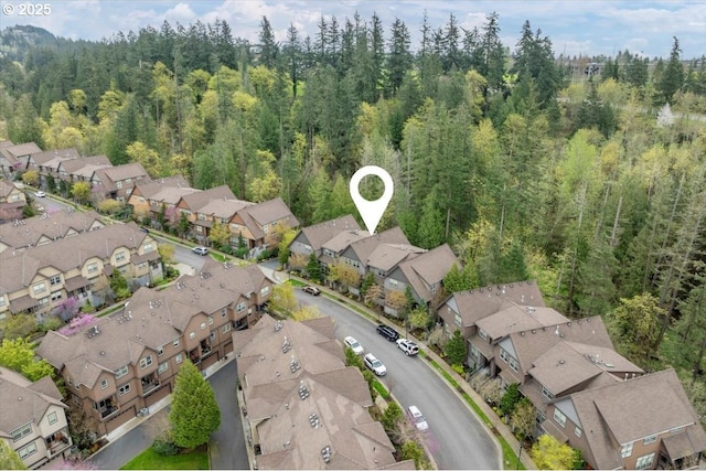 birds eye view of property with a forest view and a residential view