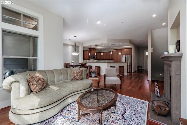 living area with recessed lighting and dark wood-style floors