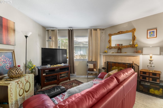living area featuring carpet, a tiled fireplace, and baseboards