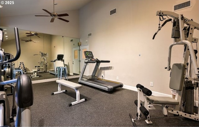 workout area featuring ceiling fan, high vaulted ceiling, and baseboards