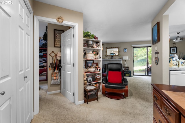 living area with light carpet and baseboards