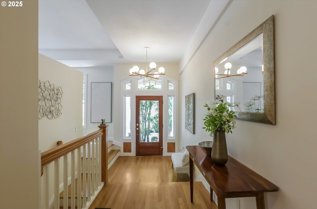 entrance foyer with a chandelier and wood finished floors