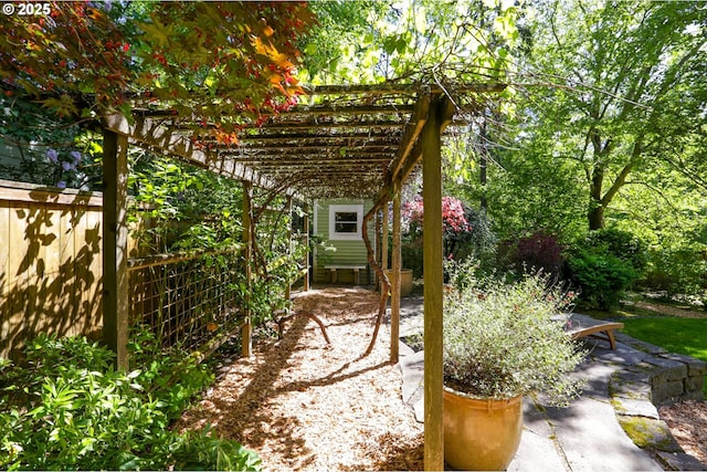 view of yard featuring a pergola, fence, and a patio