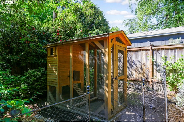 view of poultry coop featuring fence
