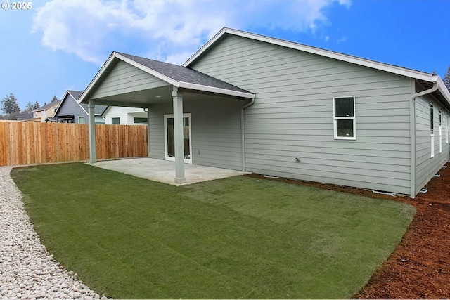 back of house featuring a yard and a patio