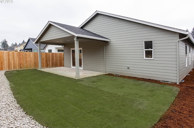 rear view of property with a patio area and a lawn