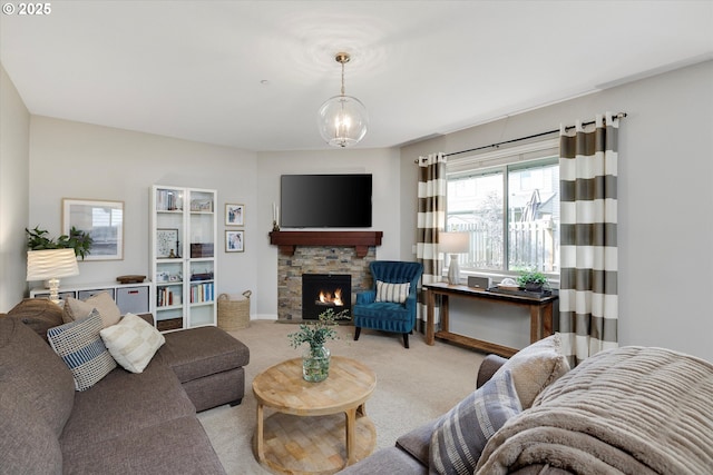 carpeted living room featuring a fireplace, baseboards, and a chandelier