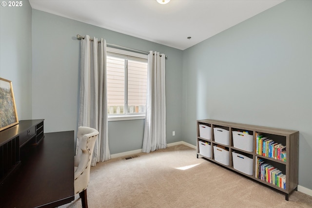 carpeted home office featuring baseboards