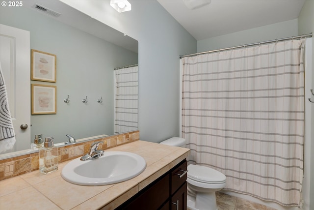 full bath featuring toilet, vanity, and tile patterned floors