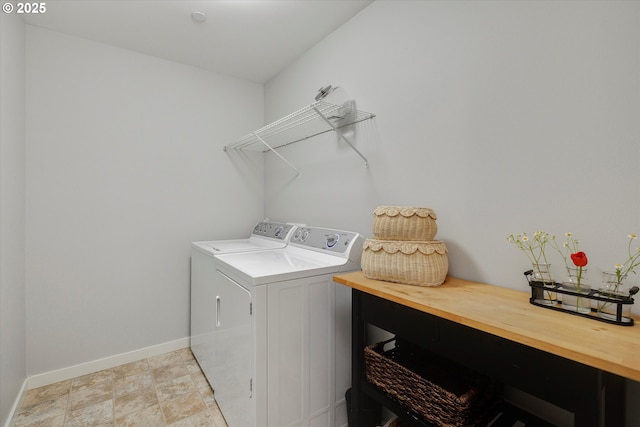 laundry area featuring washer and clothes dryer and baseboards