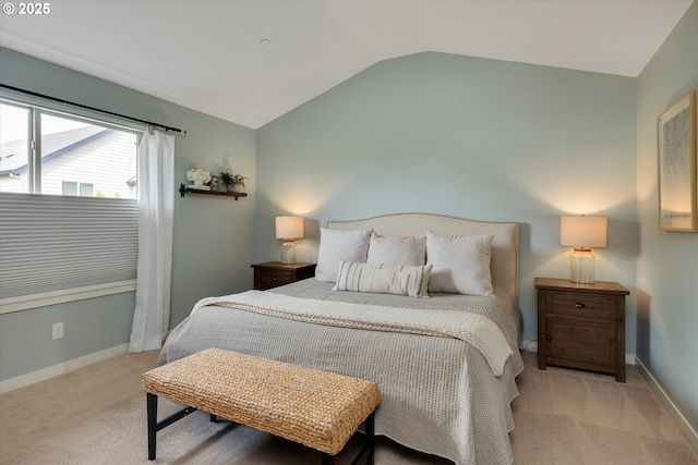 bedroom with lofted ceiling, carpet flooring, and baseboards