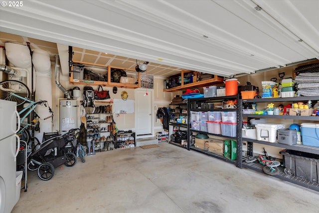 garage with strapped water heater and freestanding refrigerator