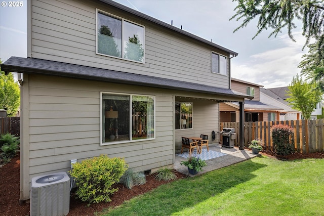 rear view of house featuring a patio and central AC