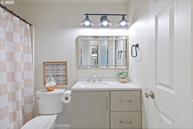 bathroom with vanity, a shower with curtain, and toilet